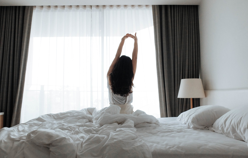 Woman stretching on bed